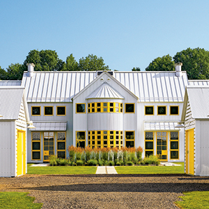 Picture of a beautiful white home with yellow accents